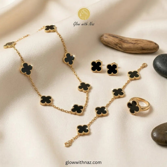 Royal Clover 4-Piece Complete Black Clover Stainless Steel Jewelry Set - Royal Clover 4-Piece Complete Black Clover Stainless Steel Jewelry SetJewelryGlow with NazGlow With NazN-N001N-N001Elevate your style with this luxury 4-piece stainless steel black clover jewelry set featuring a necklace, bracelet, earrings, and ring on a soft beige background.