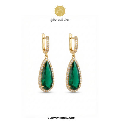 A pair of gold teardrop drop earrings with large green gemstones and small clear stones, shown on a white background with Glow with Naz branding. studs earrings, small earrings, girls earrings, simple earrings, earrings for girls, black earrings, earrings, ear rings, earrings tops, stud earrings, tops earrings, aesthetic earrings, hoop earrings, drop earrings, diamond earrings, pink earrings, green earrings, ear ring, earrings for women, flower earrings, golden earrings, bali earrings, ear jewellery, cute e