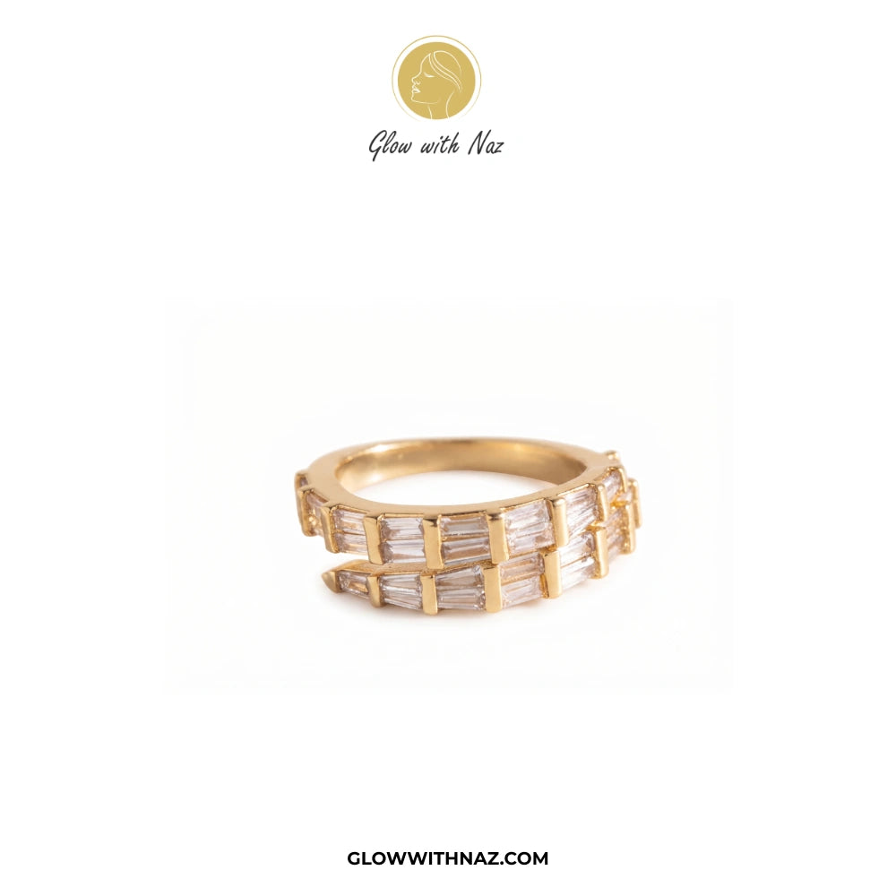 A gold band ring featuring multiple channels of baguette-cut clear stones, displayed on a clean white background with the brand logo 'Glow with Naz' at the top and 'GLOWWITHNAZ.COM' at the bottom. ring, girls rings, rings for girls, rings simple, simple rings, stainless steel jewelry, jewellery set, aesthetic jewelry, simple jewellery, chain, jewelry, artificial jewellery