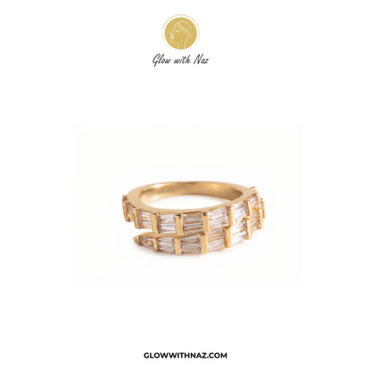 A gold band ring featuring multiple channels of baguette-cut clear stones, displayed on a clean white background with the brand logo 'Glow with Naz' at the top and 'GLOWWITHNAZ.COM' at the bottom. ring, girls rings, rings for girls, rings simple, simple rings, stainless steel jewelry, jewellery set, aesthetic jewelry, simple jewellery, chain, jewelry, artificial jewellery