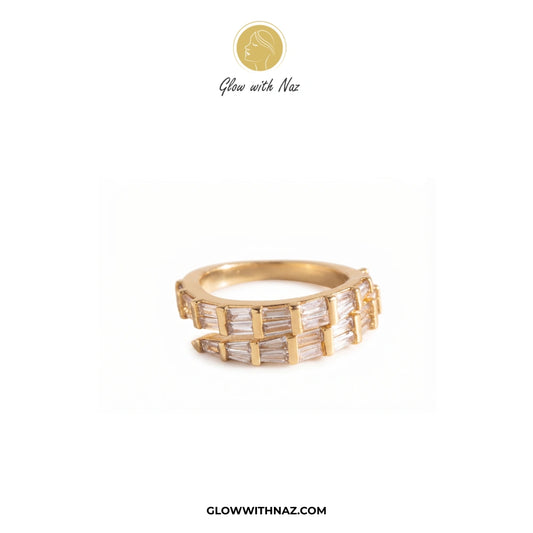 A gold band ring featuring multiple channels of baguette-cut clear stones, displayed on a clean white background with the brand logo 'Glow with Naz' at the top and 'GLOWWITHNAZ.COM' at the bottom. ring, girls rings, rings for girls, rings simple, simple rings, stainless steel jewelry, jewellery set, aesthetic jewelry, simple jewellery, chain, jewelry, artificial jewellery