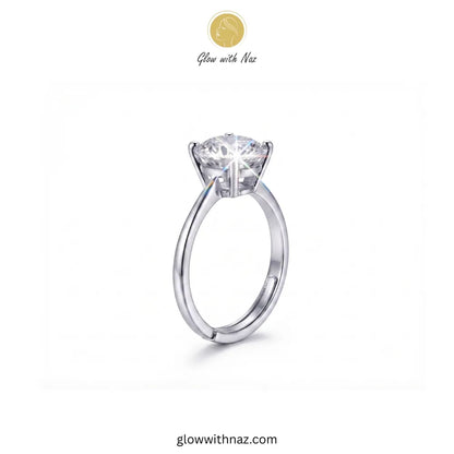 A silver solitaire engagement ring with a round brilliant-cut diamond center stone, shown on a plain white background with the brand logo 'Glow with Naz' at the top. ring, girls rings, rings for girls, rings simple, simple rings, stainless steel jewelry, jewellery set, aesthetic jewelry, simple jewellery, chain, jewelry, artificial jewellery