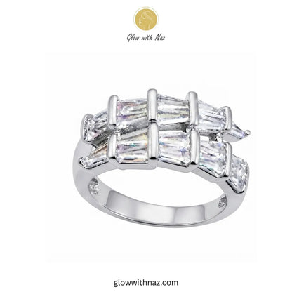 A silver-tone ring featuring a double row of baguette-cut clear stones with triangular marquise-cut stones on the sides, shown on a plain white background with Glow with Naz branding. ring, girls rings, rings for girls, rings simple, simple rings, stainless steel jewelry, jewellery set, aesthetic jewelry, simple jewellery, chain, jewelry, artificial jewellery