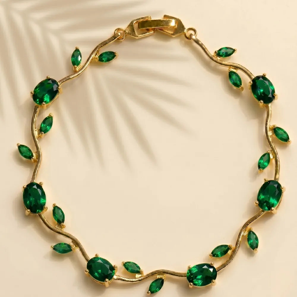 Gold bracelet with green gemstones on a beige background Tulip Rapunzel bracelet, floral tulip bracelet, Rapunzel inspired jewelry, aesthetic tulip bracelet, trendy charm bracelet, stainless steel tulip bracelet, gold plated flower bracelet, delicate floral wrist accessory, cute aesthetic jewelry, viral tulip bracelet, Rapunzel theme accessories, dainty floral bracelet, crystal tulip charm, stacking bracelets for women, minimalist floral jewelry, spring aesthetic bracelet, elegant tulip wristband, affordabl