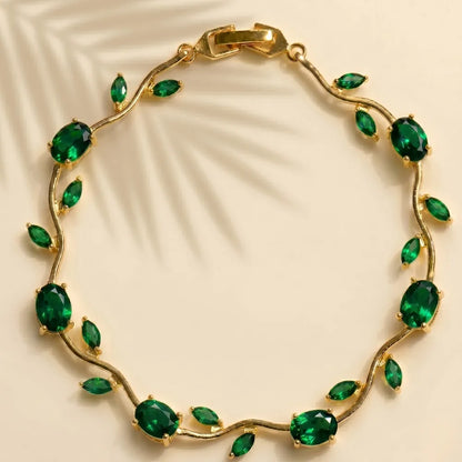 Gold bracelet with green gemstones on a beige background Tulip Rapunzel bracelet, floral tulip bracelet, Rapunzel inspired jewelry, aesthetic tulip bracelet, trendy charm bracelet, stainless steel tulip bracelet, gold plated flower bracelet, delicate floral wrist accessory, cute aesthetic jewelry, viral tulip bracelet, Rapunzel theme accessories, dainty floral bracelet, crystal tulip charm, stacking bracelets for women, minimalist floral jewelry, spring aesthetic bracelet, elegant tulip wristband, affordabl