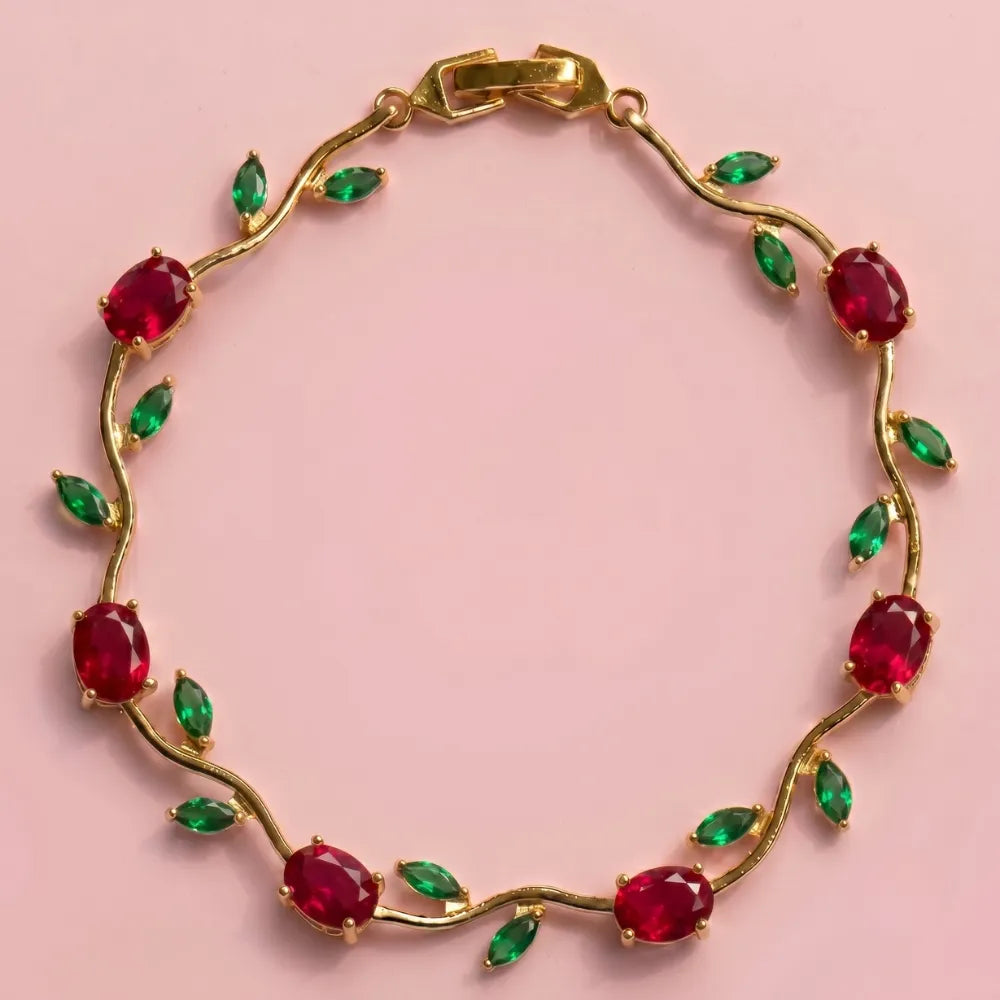 Gold bracelet with red and green gemstones on a pink background Tulip Rapunzel bracelet, floral tulip bracelet, Rapunzel inspired jewelry, aesthetic tulip bracelet, trendy charm bracelet, stainless steel tulip bracelet, gold plated flower bracelet, delicate floral wrist accessory, cute aesthetic jewelry, viral tulip bracelet, Rapunzel theme accessories, dainty floral bracelet, crystal tulip charm, stacking bracelets for women, minimalist floral jewelry, spring aesthetic bracelet, elegant tulip wristband, af