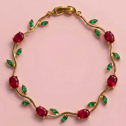 Gold bracelet with red and green gemstones on a pink background Tulip Rapunzel bracelet, floral tulip bracelet, Rapunzel inspired jewelry, aesthetic tulip bracelet, trendy charm bracelet, stainless steel tulip bracelet, gold plated flower bracelet, delicate floral wrist accessory, cute aesthetic jewelry, viral tulip bracelet, Rapunzel theme accessories, dainty floral bracelet, crystal tulip charm, stacking bracelets for women, minimalist floral jewelry, spring aesthetic bracelet, elegant tulip wristband, af