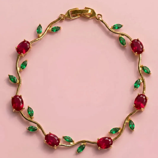 Gold bracelet with red and green gemstones on a pink background Tulip Rapunzel bracelet, floral tulip bracelet, Rapunzel inspired jewelry, aesthetic tulip bracelet, trendy charm bracelet, stainless steel tulip bracelet, gold plated flower bracelet, delicate floral wrist accessory, cute aesthetic jewelry, viral tulip bracelet, Rapunzel theme accessories, dainty floral bracelet, crystal tulip charm, stacking bracelets for women, minimalist floral jewelry, spring aesthetic bracelet, elegant tulip wristband, af