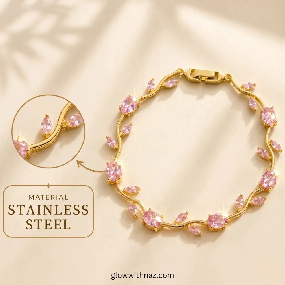 Gold-toned stainless steel bracelet with pink marquise and oval stones, shown on a warm beige background with a circular inset detail and text reading 'MATERIAL STAINLESS STEEL'. Tulip Rapunzel bracelet, floral tulip bracelet, Rapunzel inspired jewelry, aesthetic tulip bracelet, trendy charm bracelet, stainless steel tulip bracelet, gold plated flower bracelet, delicate floral wrist accessory, cute aesthetic jewelry, viral tulip bracelet, Rapunzel theme accessories, dainty floral bracelet, crystal tulip cha