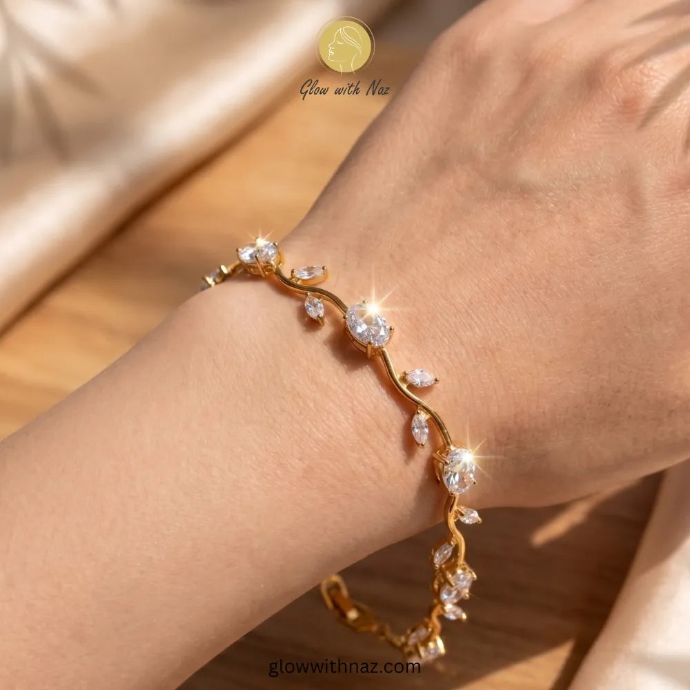 Gold bracelet with clear stones on a wrist, brand 'Glow with Naz' visible Tulip Rapunzel bracelet, floral tulip bracelet, Rapunzel inspired jewelry, aesthetic tulip bracelet, trendy charm bracelet, stainless steel tulip bracelet, gold plated flower bracelet, delicate floral wrist accessory, cute aesthetic jewelry, viral tulip bracelet, Rapunzel theme accessories, dainty floral bracelet, crystal tulip charm, stacking bracelets for women, minimalist floral jewelry, spring aesthetic bracelet, elegant tulip wri