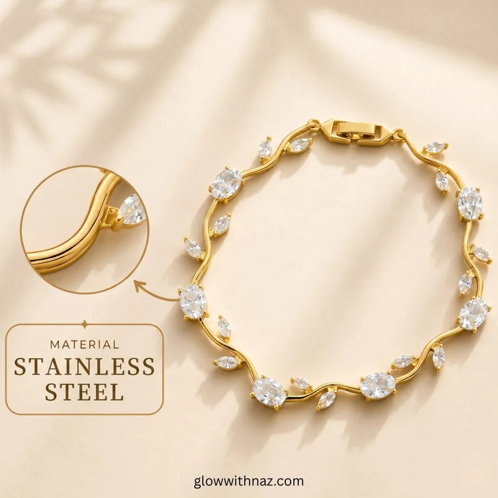 Gold-toned stainless steel bracelet with clear marquise and round stones, shown on a warm beige background with a circular inset highlighting the metal and a text callout reading 'MATERIAL Tulip Rapunzel bracelet, floral tulip bracelet, Rapunzel inspired jewelry, aesthetic tulip bracelet, trendy charm bracelet, stainless steel tulip bracelet, gold plated flower bracelet, delicate floral wrist accessory, cute aesthetic jewelry, viral tulip bracelet, Rapunzel theme accessories, dainty floral STAINLESS STEEL'.