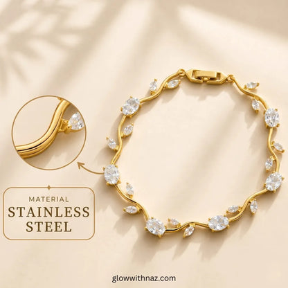 Gold-toned stainless steel bracelet with clear marquise and round stones, shown on a warm beige background with a circular inset highlighting the metal and a text callout reading 'MATERIAL Tulip Rapunzel bracelet, floral tulip bracelet, Rapunzel inspired jewelry, aesthetic tulip bracelet, trendy charm bracelet, stainless steel tulip bracelet, gold plated flower bracelet, delicate floral wrist accessory, cute aesthetic jewelry, viral tulip bracelet, Rapunzel theme accessories, dainty floral STAINLESS STEEL'.