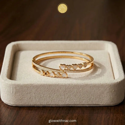 Bundle Offer: Anti-Tarnish Heart Bangle Bracelet & Stainless Steel White Ring - Bundle Offer: Anti-Tarnish Heart Bangle Bracelet & Stainless Steel White RingJewelryGlow With NazGlow With Naz6Elegant minimalist jewelry showcasing a stunning gold-plated stainless steel bracelet featuring mother-of-pearl and crystal hearts.