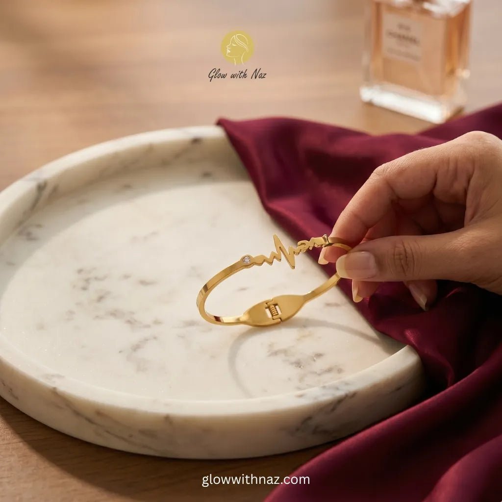 Gold Heartbeat Bracelet - Gold Heartbeat BraceletJewelryGlow With NazGlow With NazN-B038N-B038Gold heartbeat ECG bracelet with zircon stone held over marble tray — anti - tarnish stainless steel bangle online in Pakistan by Glow with Naz