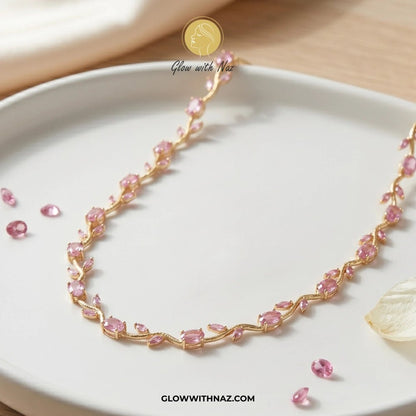 Gold Plated Stainless Steel Pink Tulip Necklace For Women - Gold Plated Stainless Steel Pink Tulip Necklace For WomenJewelryGlow With NazGlow With NazN0050N0050Pink tulip Necklace with pink stones on a white plate, brand 'Glow with Naz' visible