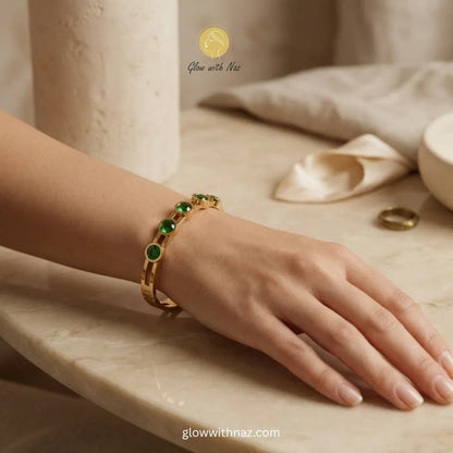 Waterproof Green Stone Gold Bangle Bracelet - Waterproof Green Stone Gold Bangle BraceletJewelryGlow With NazGlow With NazN-B020N-B020Woman wearing gold bangle with green stones on wrist, elegant style